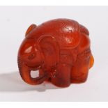 Japanese netsuke, the amber effect elephant signed to the base, 30mm high