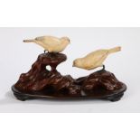 Japanese carved ivory figural group depicting two birds on a naturalistically carved wooden base,