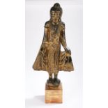 Thailand carved buddha, standing position with arms slightly raised standing on a plinth base with