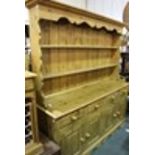 Victorian style pine dresser, the plate rack with an undulating rail above two shelves