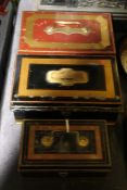 Three late Victorian cash tins, with ebonised, red and gilt decoration, the largest 26cm wide (3)