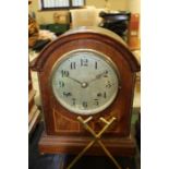 Edwardian walnut and boxwood strung mantel clock, with arched pediment, the silvered dial with