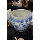 Oriental blue and white porcelain jardiniere, raised on a hardwood stand