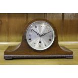 Edwardian walnut mantel clock, the arched case and silvered dial with Arabic numerals, 38cm wide