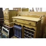 Pine washstand, the two frieze drawers above an undulating arched rail, with wine rack and a storage