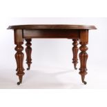 Victorian mahogany extending dining table, the circular top above gadrooned legs and castors,