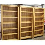 Three light oak bookcases, each with six shelves, raised on square feet, 96cm x 198cm (3)