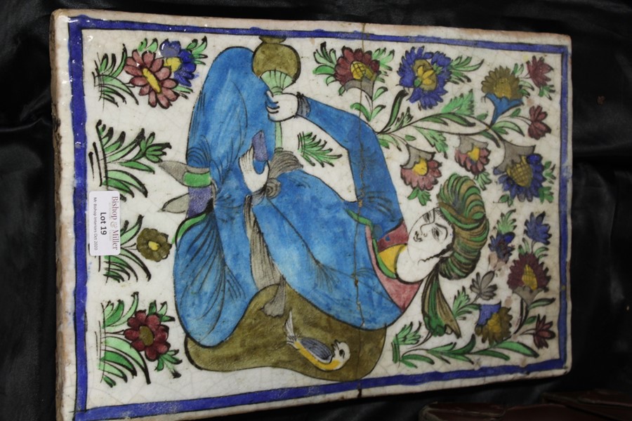 Persian Qajar pottery tile, of a seated figure pouring from a bottle, with a flower surround, 23cm x - Image 4 of 4