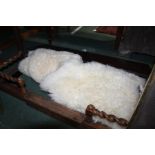 Two sheepskin and lambskin rugs, 110cm and 170cm long