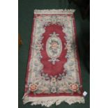 Rectangular Chinese rug, the wine red ground with foliate decoration, 63cm x 126cm