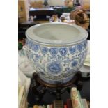 Oriental blue and white porcelain jardiniere, raised on a hardwood stand