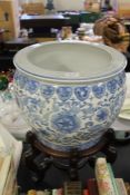 Oriental blue and white porcelain jardiniere, raised on a hardwood stand
