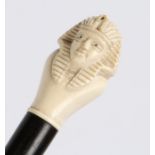 Early 20th Century ivory swagger stick, with an Egyptian carved ivory head to the top, 61cm high
