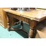 20th Century oak draw leaf dining table, the rectangular top on turned legs, united by square