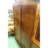Basil Sharland oak cupboard, the arched cornice above two paneled doors, opening to reveal four