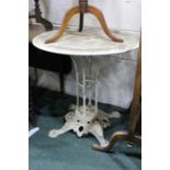 White painted metal garden table, the circular top with pierced scrolling decoration, 70cm high
