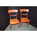 Pair of mahogany dining chairs, with curved cresting rails and solid seats, on turned legs (2)