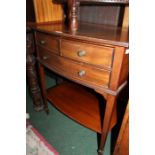 Edwardian mahogany side table, the rectangular bow front top raised on three frieze drawers above an