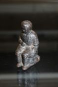 Victorian cast metal figure depicting a young child on a chamber pot