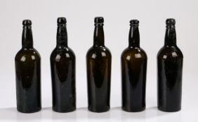 Five 19th Century brown glass bottles, with ring tops above the cylinder bodies, 30cm high, (5)