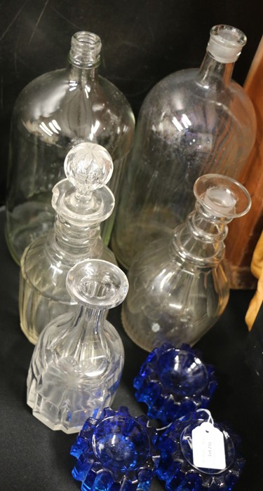 Two glass bottles, three glass decanters, three blue glass piano stands (8)