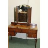 Walnut dressing table, with arched triple mirror above a base with arrangement of four drawers,