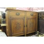 Art Nouveau style walnut sideboard, with two frieze drawers above two carved panelled doors,