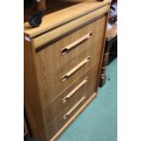 Mid 20th Century teak chest of five drawers, the cushion front concealed drawer above four drawers