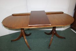Mahogany low cupboard, together with a mahogany twin pillar dining table, (2)