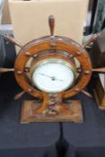 Aneroid barometer, housed in an oak ships wheel case with mythical sea creature and trident carved