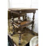 Victorian walnut table, the carved top raised above an under tier with pierced rail, on tapered