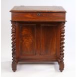 Victorian mahogany Davenport, the slopping fall above a deep frieze and one side with small drawers,