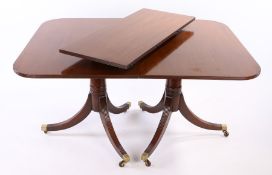 Regency style mahogany twin pillar dining table, with a rounded rectangular top above twin