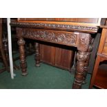 Victorian oak card table, the hinged leaf enclosing a green velvet lined interior and trailing