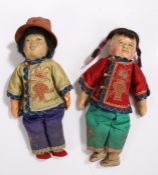 Two Oriental inspired dolls, one with bisque head the other with plastic head, both wearing silk