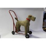 20th Century toy dog, on a wheeled red metal frame