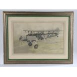 Bi-plane K4357 in flight, photograph heightened with crayon, housed in a silvered and green glazed