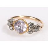Gold coloured metal ring, the central purple paste flanked by three rose cut diamonds to each