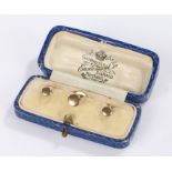 Cased set of three 9 carat gold buttons, 2.4g