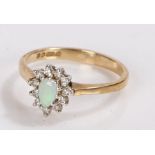 9 carat gold ring set with an oval opal surrounded by diamond chips, ring size L, 1.9g