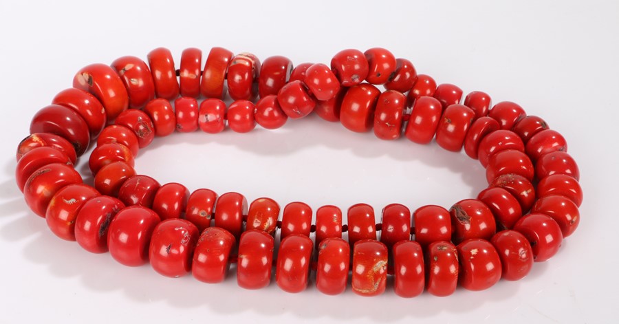 Substantial coral necklace, formed from graduated coral discs, the largest 34.5mm diameter, 104cm