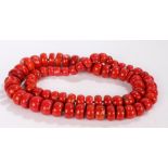 Substantial coral necklace, formed from graduated coral discs, the largest 34.5mm diameter, 104cm