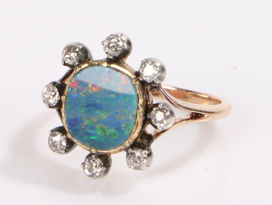 Opal and diamond ring, the central 1.5ct opal surrounded by eight diamonds estimated diamond