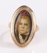 Gold coloured metal ring, the oval head set with a print depicting Sir Walter Scott FRSE FSA Scot (