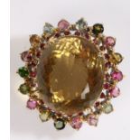 Citrine & tourmaline brooch, the central oval citrine surrounded by a band of polychrome