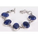 Silver bracelet set with five oval lapis lazuli panels