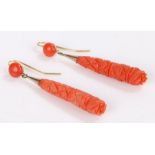 Pair of carved coral earrings, the drops with geometric decoration and gilt mounts, 10.3g