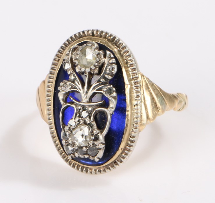 19th Century gold ring, the oval blue enamel head with a flowering urn set with rose cut diamonds,