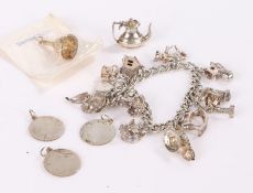 Silver charm bracelet set with twelve charms, four loose charms, 70g