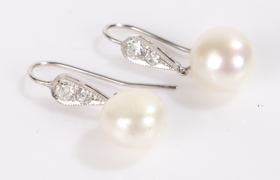 Pair of pearl and diamond earrings, each earring with a hanging pearl above two diamonds, 4g